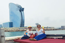 Two friends enjoying  the sailing tour with the W Hotel in the back