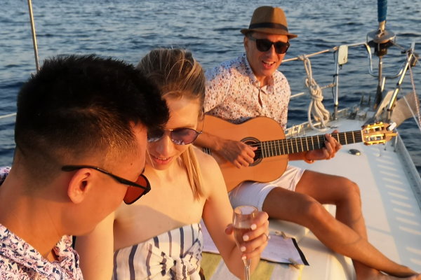 Live guitar music on the sailing boat at the sunset