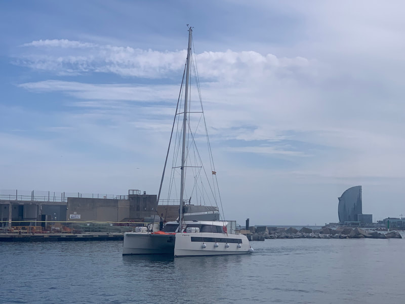 The catamaran for rent leaving the Olympic Port