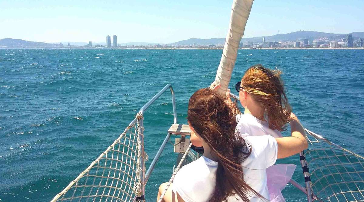 Two girls enjoying the sailing trip in the bow.